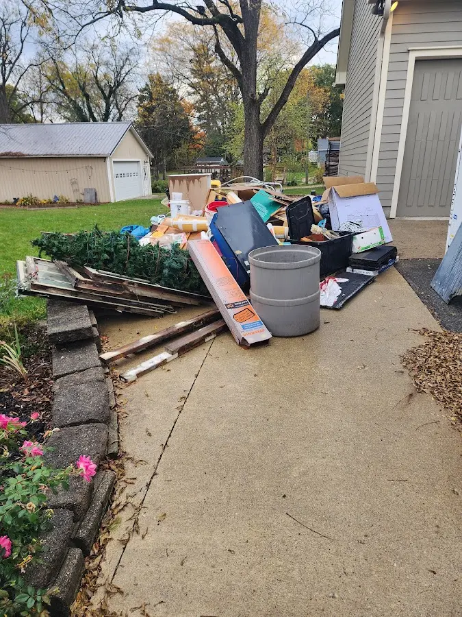 Dumpster being loaded with debris for 10 Yard Dumpster Rental in Penrose